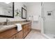 Bathroom featuring double vanity, granite countertops, and glass shower with subway tile at 4704 Lancashire Dr, Raleigh, NC 27613