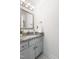 Bathroom features grey vanity with granite countertop and a framed mirror at 4704 Lancashire Dr, Raleigh, NC 27613