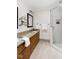 Bathroom featuring double vanity, granite countertops, and glass shower with subway tile at 4704 Lancashire Dr, Raleigh, NC 27613