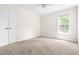 Cozy bedroom with neutral carpet, natural light, and double door closet at 4704 Lancashire Dr, Raleigh, NC 27613