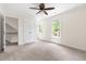 Bedroom with neutral carpet, a ceiling fan, and bright natural light at 4704 Lancashire Dr, Raleigh, NC 27613