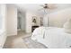 Spacious bedroom with neutral carpet, ceiling fan, and bright light from the windows at 4704 Lancashire Dr, Raleigh, NC 27613