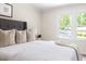 Bedroom with large window, plush bedding and warm, neutral decor at 4704 Lancashire Dr, Raleigh, NC 27613
