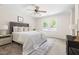 Bright bedroom featuring neutral paint, large window, and a comfortable bed at 4704 Lancashire Dr, Raleigh, NC 27613