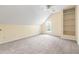 Spacious bedroom with neutral carpet, natural light and a vaulted ceiling offers built in shelving at 4704 Lancashire Dr, Raleigh, NC 27613