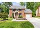 Charming two-story brick home with a well-manicured lawn and attached garage at 4704 Lancashire Dr, Raleigh, NC 27613