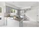 Bright kitchen featuring gray cabinets, granite countertops, and tile backsplash at 4704 Lancashire Dr, Raleigh, NC 27613