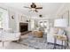Elegant living room with a brick fireplace, ceiling fans, and lots of natural light at 4704 Lancashire Dr, Raleigh, NC 27613