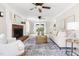 Cozy living room featuring a classic brick fireplace, neutral decor, and sliding glass doors at 4704 Lancashire Dr, Raleigh, NC 27613