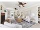 Sunlit living room featuring a brick fireplace, stylish furniture, and backyard access at 4704 Lancashire Dr, Raleigh, NC 27613