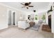Bright living room with neutral tones, ceiling fans, a brick fireplace, and plush seating at 4704 Lancashire Dr, Raleigh, NC 27613
