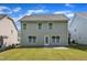 The back of a home with a manicured backyard featuring a concrete patio and a blue sky at 4727 Smarty Jones Dr, Knightdale, NC 27545
