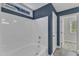 Bright bathroom featuring a white shower-tub combination and a window for natural light at 4727 Smarty Jones Dr, Knightdale, NC 27545