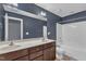 Bathroom featuring double sinks with counter space and a white shower-tub combination at 4727 Smarty Jones Dr, Knightdale, NC 27545