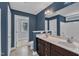 Bathroom with dual sinks, dark wood cabinets, and neutral colored walls at 4727 Smarty Jones Dr, Knightdale, NC 27545