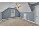 Upstairs bedroom featuring carpet, window, ceiling fan and a small storage space at 4727 Smarty Jones Dr, Knightdale, NC 27545