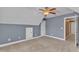 Neutral bedroom featuring a ceiling fan, gray walls and an attic access door at 4727 Smarty Jones Dr, Knightdale, NC 27545
