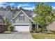 Charming two-story home featuring a two-car garage, manicured lawn, and mature landscaping at 4727 Smarty Jones Dr, Knightdale, NC 27545