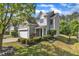 Charming two-story home featuring a two-car garage, manicured lawn, and mature landscaping at 4727 Smarty Jones Dr, Knightdale, NC 27545