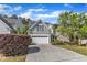 Charming two-story home featuring a two-car garage, manicured lawn, and mature landscaping at 4727 Smarty Jones Dr, Knightdale, NC 27545