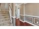 Elegant hallway with hardwood floors, decorative wall trim, and a staircase leading upstairs at 4727 Smarty Jones Dr, Knightdale, NC 27545