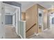 Hallway with multiple doorways and staircase with light-colored walls and neutral carpeting at 4727 Smarty Jones Dr, Knightdale, NC 27545