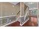 Elegant hallway with hardwood floors, decorative wall trim, and a staircase leading upstairs at 4727 Smarty Jones Dr, Knightdale, NC 27545