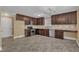 Updated kitchen featuring dark cabinets, stainless steel appliances, and a modern chandelier at 4727 Smarty Jones Dr, Knightdale, NC 27545