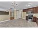 Bright kitchen with stainless steel appliances, dark cabinets, and adjacent breakfast area at 4727 Smarty Jones Dr, Knightdale, NC 27545