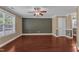 Living room with hardwood floors, ceiling fan, a large window and a neutral wall color scheme at 4727 Smarty Jones Dr, Knightdale, NC 27545