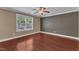 Living room with hardwood floors, ceiling fan, neutral walls, large window allowing natural light at 4727 Smarty Jones Dr, Knightdale, NC 27545