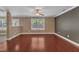 Spacious living room features hardwood floors, neutral walls, large windows, and a ceiling fan at 4727 Smarty Jones Dr, Knightdale, NC 27545