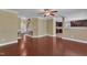 Open-concept living room showing hardwood floors and an entrance to the kitchen and staircase at 4727 Smarty Jones Dr, Knightdale, NC 27545