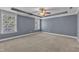 Spacious main bedroom with large windows, tray ceilings, and a ceiling fan at 4727 Smarty Jones Dr, Knightdale, NC 27545