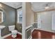 Stylish powder room with a pedestal sink, toilet, and window for natural light at 4727 Smarty Jones Dr, Knightdale, NC 27545