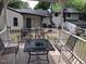 Relaxing back porch with a table and four chairs, offering a great spot for outdoor dining at 5002 Wickham Rd, Raleigh, NC 27606