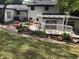 A lush backyard featuring a white pergola, manicured landscaping, and a well-maintained lawn at 5002 Wickham Rd, Raleigh, NC 27606