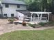A backyard view featuring a charming patio with a pergola, a small pond, and lush landscaping at 5002 Wickham Rd, Raleigh, NC 27606
