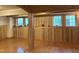 Large basement features hardwood floors, wood walls and trim, and bright windows at 5002 Wickham Rd, Raleigh, NC 27606