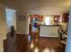 Open-concept living area showcasing hardwood floors and a modern kitchen with a breakfast bar at 5002 Wickham Rd, Raleigh, NC 27606