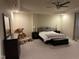 Well-lit main bedroom with a ceiling fan and tray ceilings accompanied by an oversized teddy bear at 5002 Wickham Rd, Raleigh, NC 27606