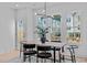 Bright dining room featuring large windows, contemporary light fixture, and a wood table at 5049 Lundy Dr # 102, Raleigh, NC 27606
