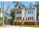 Rear exterior of the townhome showcasing a wooden deck and well-maintained landscaping at 5049 Lundy Dr # 102, Raleigh, NC 27606