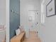 Inviting foyer with bench seating, decorative wall hooks, and a convenient powder room at 5049 Lundy Dr # 102, Raleigh, NC 27606