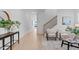 Inviting hallway featuring light hardwood floors, stairs, and contemporary decor at 5049 Lundy Dr # 102, Raleigh, NC 27606
