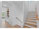Bright hallway featuring hardwood stairs, built in cabinets, and modern design elements at 5049 Lundy Dr # 102, Raleigh, NC 27606