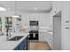 Modern kitchen features white cabinets, stainless steel appliances, and stylish countertops at 5049 Lundy Dr # 102, Raleigh, NC 27606