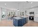 Bright kitchen boasts white cabinets, stainless appliances, and a large island, adjacent to the dining area at 5049 Lundy Dr # 102, Raleigh, NC 27606