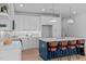 Well-lit kitchen featuring a center island with barstool seating, white cabinetry and modern appliances at 5049 Lundy Dr # 102, Raleigh, NC 27606