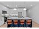 Kitchen features white cabinets, stainless steel appliances, and a large island with barstool seating at 5049 Lundy Dr # 102, Raleigh, NC 27606